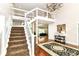 Grand foyer features a dramatic staircase, chandelier, and hardwood floors with a stylish rug at 9790 Summerlakes Dr, Carmel, IN 46032