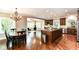 Open concept kitchen with hardwood floors, custom cabinets, and stainless appliances at 9790 Summerlakes Dr, Carmel, IN 46032