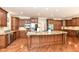 Spacious kitchen features a large island with granite countertops, stainless steel appliances, and hardwood floors at 9790 Summerlakes Dr, Carmel, IN 46032