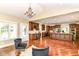 Open-concept living area showcasing the kitchen with island, wet bar area, hardwood floors, and seating at 9790 Summerlakes Dr, Carmel, IN 46032