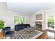 Bright living room with large window, fireplace, and hardwood floors at 9790 Summerlakes Dr, Carmel, IN 46032