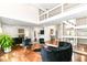 Bright living room boasts hardwood floors, fireplace, and staircase to an open, airy second level at 9790 Summerlakes Dr, Carmel, IN 46032