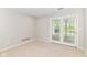Bright and airy room with neutral carpet and a glass door leading to a private outdoor area at 9790 Summerlakes Dr, Carmel, IN 46032
