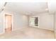 Spacious room with neutral carpet and French doors, connected to an adjacent room with a private bathroom at 9790 Summerlakes Dr, Carmel, IN 46032