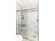 Shower with glass door and white marble tile surround including built in shelves at 9790 Summerlakes Dr, Carmel, IN 46032