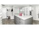 Walk-in closet with an island, wood floors, and plenty of storage space at 9790 Summerlakes Dr, Carmel, IN 46032