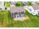 Aerial shot of backyard showing grey siding, concrete patio, and surrounding neighborhood at 9860 Gallop Ln, Fishers, IN 46040