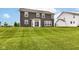 Spacious backyard with a lush lawn and a view of the home's exterior at 9860 Gallop Ln, Fishers, IN 46040