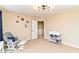 Bright bedroom features planet wall decor, chair and changing table at 9860 Gallop Ln, Fishers, IN 46040