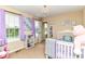 Charming Bedroom with purple accents and a cozy crib area at 9860 Gallop Ln, Fishers, IN 46040