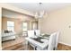 Open concept dining area with elegant chandelier and adjoins the living room at 9860 Gallop Ln, Fishers, IN 46040