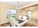 Chic dining area features a chandelier and large windows, perfect for entertaining guests at 9860 Gallop Ln, Fishers, IN 46040