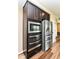 Modern stainless steel appliances, including a built-in microwave and double oven, enhancing the kitchen's functionality at 9860 Gallop Ln, Fishers, IN 46040