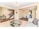 Elegant living room featuring a staircase, a modern coffee table, and a decorative chandelier at 9860 Gallop Ln, Fishers, IN 46040