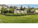 Stone pillars mark the community entrance with wooden fencing and lush landscaping at 9860 Gallop Ln, Fishers, IN 46040