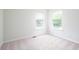 This bright bedroom has two windows and neutral carpeting at 10075 Niagara Dr, Fishers, IN 46037