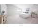 Bright bedroom featuring high ceilings, neutral tones, and ample natural light from a large window at 10075 Niagara Dr, Fishers, IN 46037