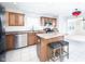 Bright kitchen features stainless steel appliances, island with seating, and tile flooring at 10075 Niagara Dr, Fishers, IN 46037