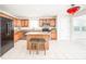 A well-lit kitchen with an island and seating area overlooks a bright, carpeted room at 10075 Niagara Dr, Fishers, IN 46037