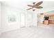 A sunlit living room provides a view to the kitchen in this open-concept home at 10075 Niagara Dr, Fishers, IN 46037