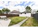 Spacious backyard with green grass, a patio, and a white garage, great for outdoor entertaining at 1043 N Beville Ave, Indianapolis, IN 46201