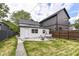 Backyard featuring a patio, a swing, green grass and a charming white brick garage at 1043 N Beville Ave, Indianapolis, IN 46201