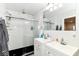 Contemporary bathroom showcasing a glass-enclosed shower and dual vanities with sleek fixtures at 1043 N Beville Ave, Indianapolis, IN 46201