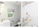 Clean bathroom with modern sink and floral shower curtain, offering a refreshing and functional space at 1043 N Beville Ave, Indianapolis, IN 46201