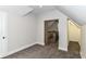 Cozy bedroom with neutral carpet, trim, and views of the home's staircase at 1043 N Beville Ave, Indianapolis, IN 46201