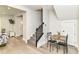 Inviting entryway with hardwood floors, staircase, and dining nook with table at 1043 N Beville Ave, Indianapolis, IN 46201