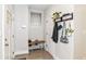 Organized entryway with shoe storage, bench, and stylish coat rack with plants at 1043 N Beville Ave, Indianapolis, IN 46201