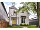 Charming two-story home with a bright yellow front door and manicured lawn at 1043 N Beville Ave, Indianapolis, IN 46201