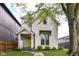 Charming two-story home with fresh landscaping and a welcoming yellow front door at 1043 N Beville Ave, Indianapolis, IN 46201