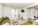 Bright living room with hardwood floors, neutral paint, and two windows, creating a comfortable atmosphere at 1043 N Beville Ave, Indianapolis, IN 46201