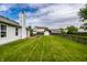 Spacious backyard view shows the lawn and a deck with seating, ideal for entertaining and outdoor enjoyment at 10551 Huckleberry Ct, Noblesville, IN 46060