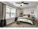 Comfortable bedroom with a large window, soft carpet, neutral colors, and ceiling fan at 10551 Huckleberry Ct, Noblesville, IN 46060