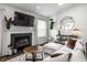 Cozy living room with a fireplace, white sofa, and stylish decor at 10551 Huckleberry Ct, Noblesville, IN 46060