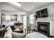 Open concept living room with fireplace, kitchen view, and skylight for bright, modern living at 10551 Huckleberry Ct, Noblesville, IN 46060
