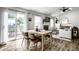 Open floorplan dining and living area with wood floors, patio access, and cozy fireplace at 10551 Huckleberry Ct, Noblesville, IN 46060