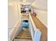 Stairway leads to finished attic with carpet, white railings, and bedroom area at 106 S Denny St, Indianapolis, IN 46201
