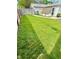 Spacious backyard with lush lawn, garden area, and mature trees, offering privacy at 106 S Denny St, Indianapolis, IN 46201