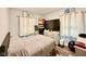 Comfortable bedroom featuring a large bed, plenty of closet space, and natural light from the large window at 106 S Denny St, Indianapolis, IN 46201