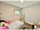 Cozy bedroom with decoratively adorned window, neutral walls and wood-look flooring at 106 S Denny St, Indianapolis, IN 46201