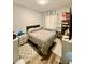 Cozy bedroom with a comfortable queen-sized bed, a mirror, and neutral decor, creating a relaxing atmosphere at 106 S Denny St, Indianapolis, IN 46201