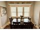 Inviting dining room featuring a wood table with seating for four and bright natural light from the three windows at 106 S Denny St, Indianapolis, IN 46201