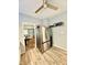 Kitchen featuring a stainless steel refrigerator and view into the living room with wood-look vinyl floors at 106 S Denny St, Indianapolis, IN 46201