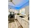 Bright kitchen with white cabinets, granite countertops, stainless steel appliances, and a large window at 106 S Denny St, Indianapolis, IN 46201