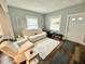 Cozy living room with a white sofa and chair, a light area rug, and plenty of natural light from the windows at 106 S Denny St, Indianapolis, IN 46201