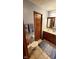 Bathroom with single sink vanity, tile floors, and modern fixtures at 1102 Redwood Dr, Brownsburg, IN 46112