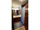 Bathroom with double vanity, wood cabinets, and shower with curtain at 1102 Redwood Dr, Brownsburg, IN 46112